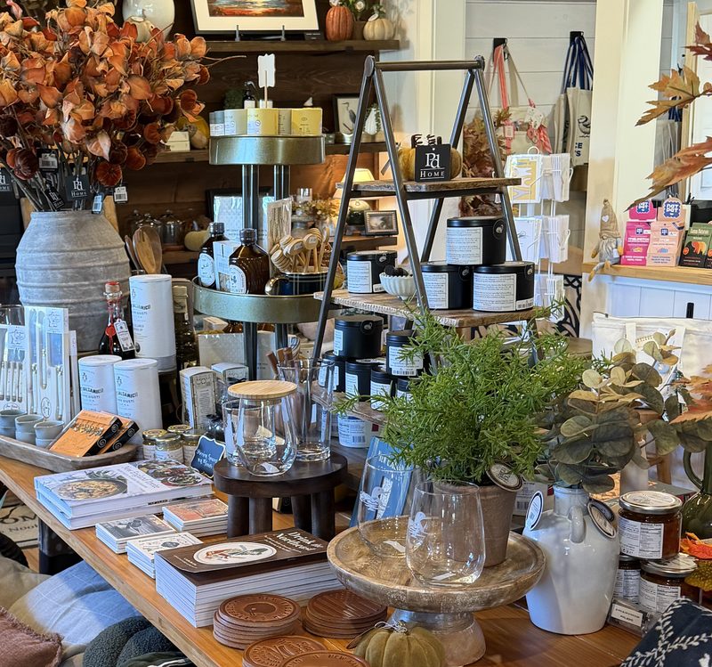 A table at Water's Nook with candles, glassware, and greenery
