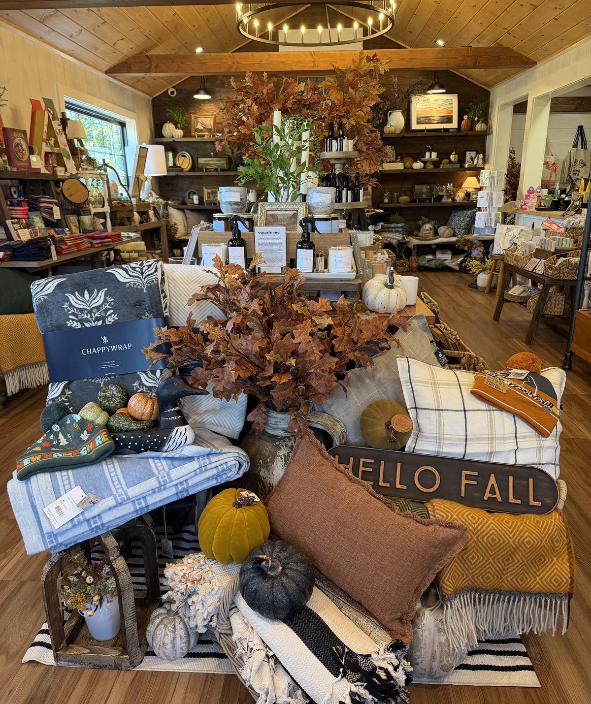 Inside Water's Nook: a fall display of throws, pillows, and pumpkins